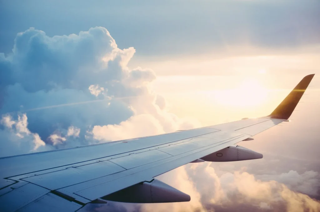Aircraft wing above clouds during a flight