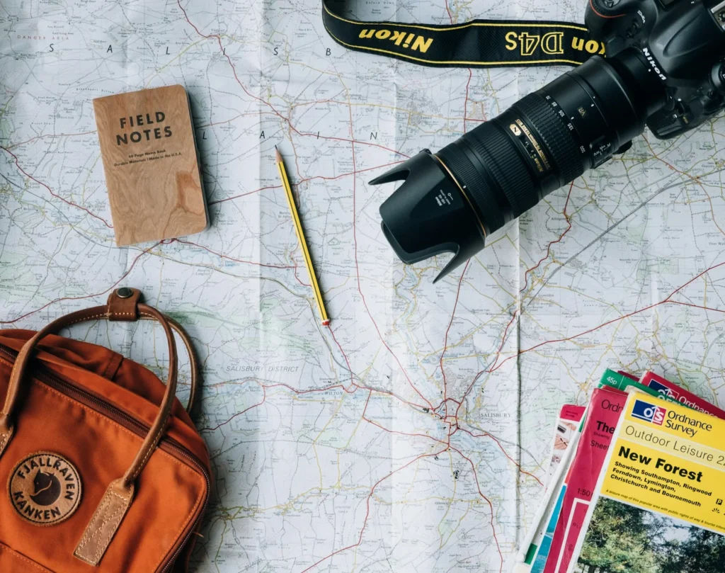 Camera and travel notebook on a map