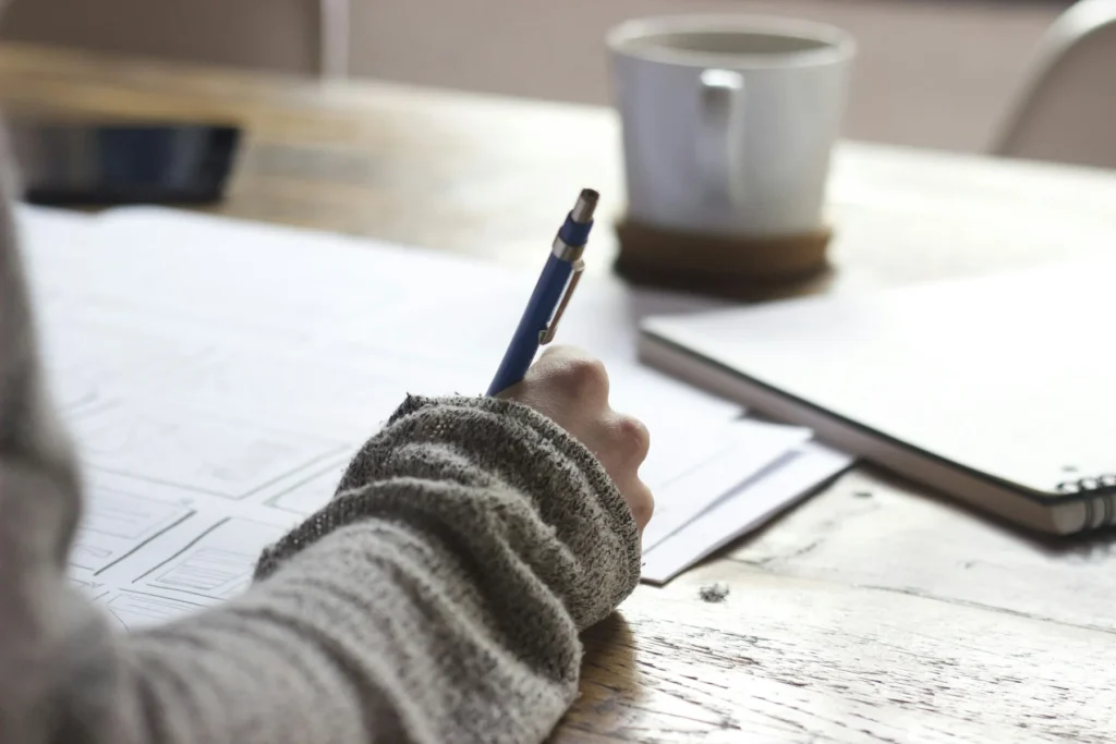 Person preparing paperwork at a desk
